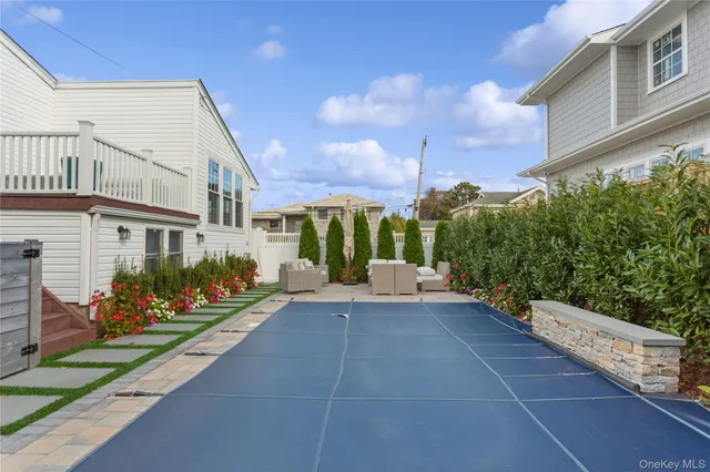 a view of a house with porch and garden