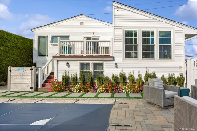 a front view of a house with lots of cars parked