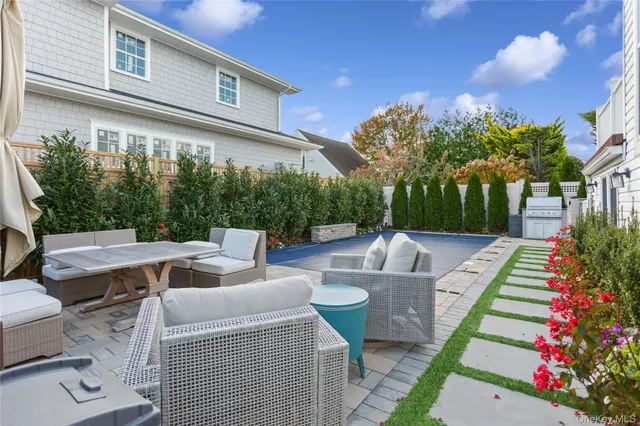 a view of a patio with couches table and chairs and potted plants