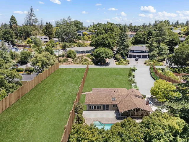 an aerial view of a house with a garden
