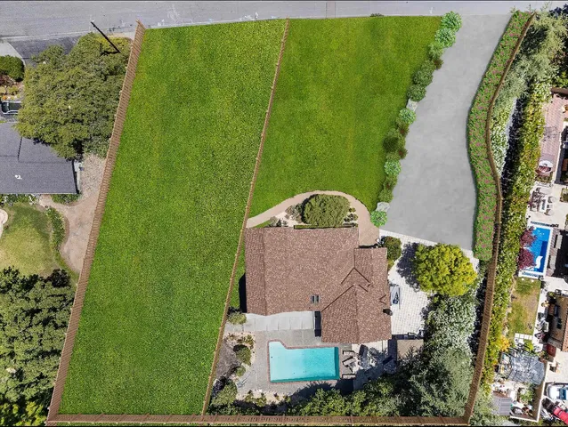an aerial view of a house with a yard swimming pool outdoor seating and outdoor seating
