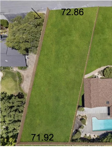 an aerial view of a residential houses with outdoor space