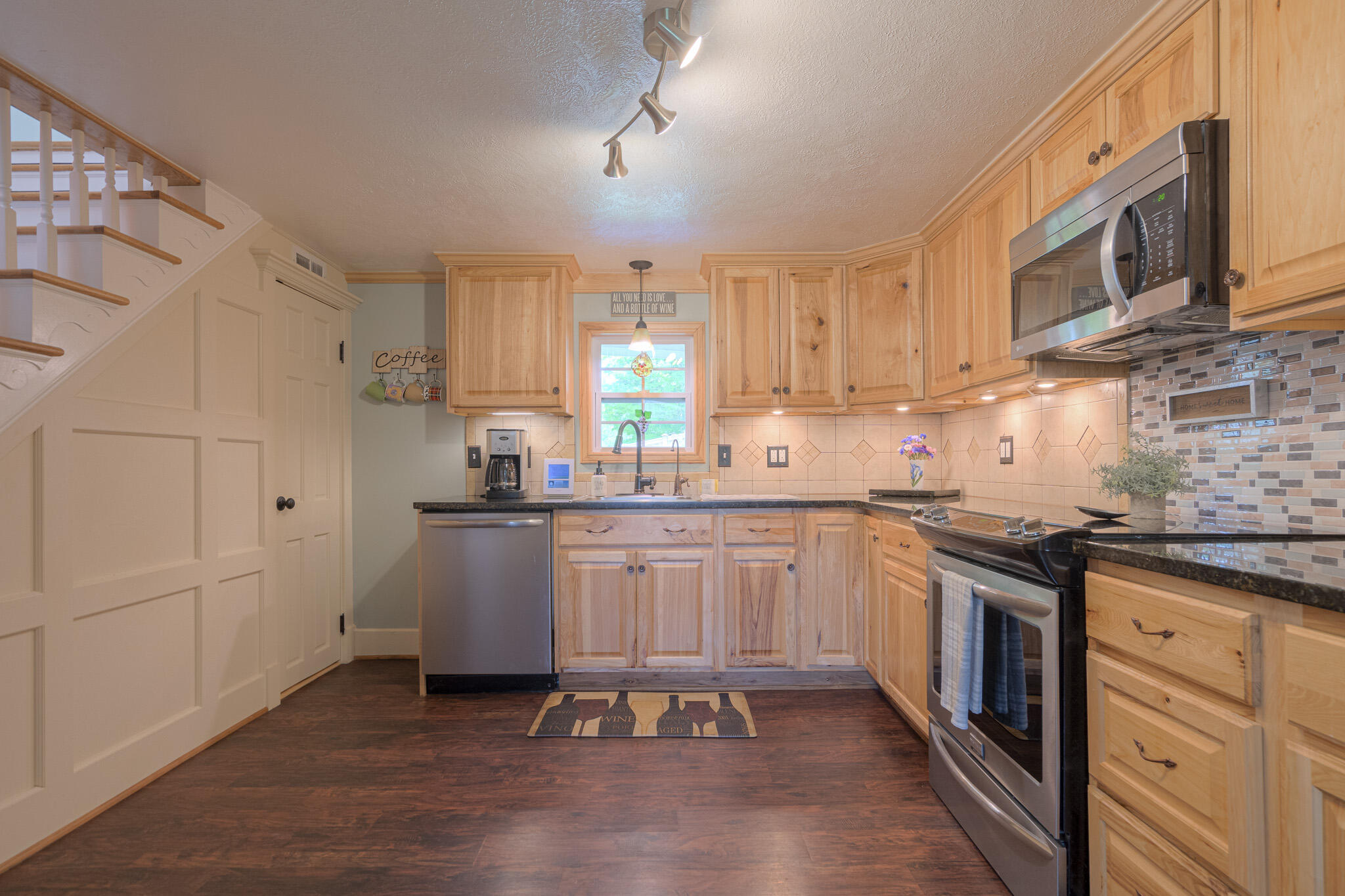 5484 Lead Mine Road Hiwassee, VA 24347 - Photo 20 of 86 a kitchen with granite countertop a sink cabinets stainless steel appliances and a counter space