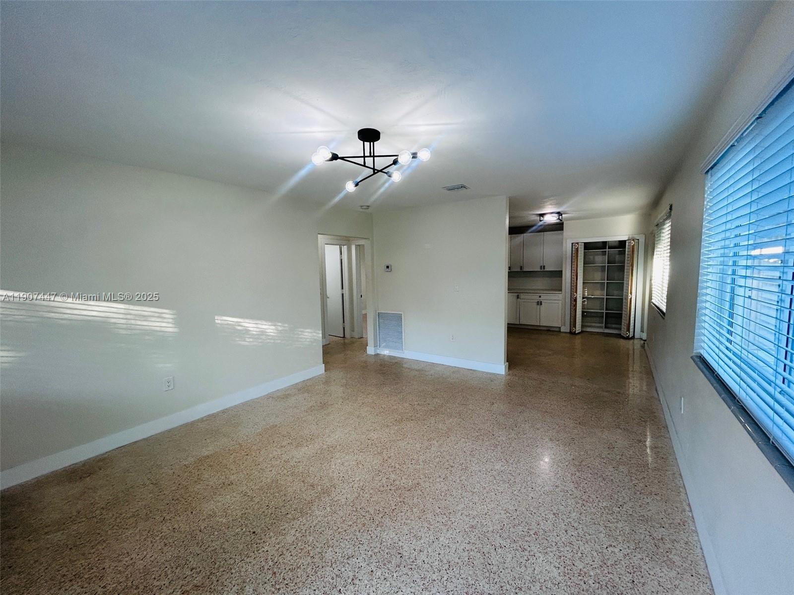 7311 Southwest 63rd Court, Unit 1 South Miami, FL 33143 - Photo 5 of 14 a view of a hallway with a chandelier
