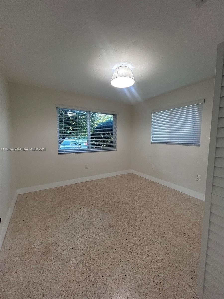 7311 Southwest 63rd Court, Unit 1 South Miami, FL 33143 - Photo 7 of 14 a view of empty room with window