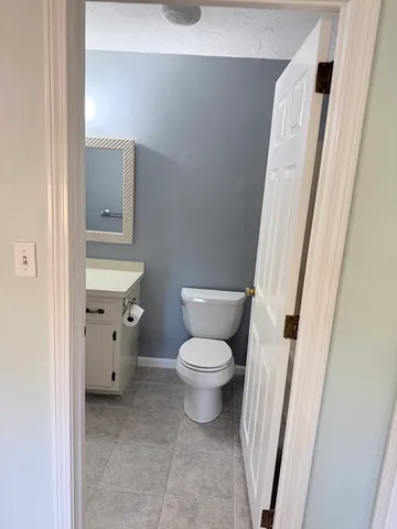 a white toilet sitting next to a small sink