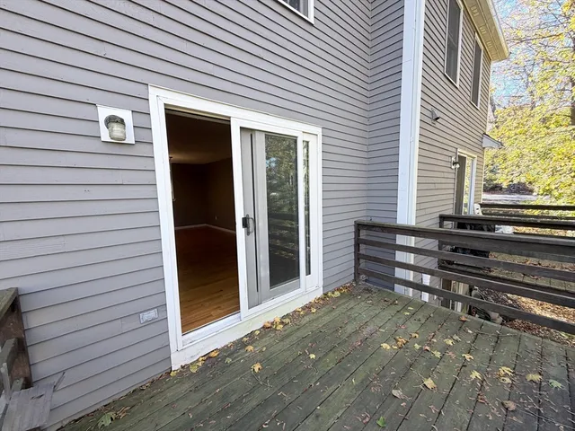 a view of a house with a door and wooden bench