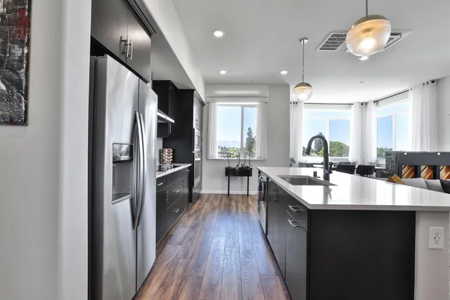 a dining room with furniture window and wooden floor