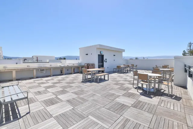an aerial view of multiple house with a mountain view