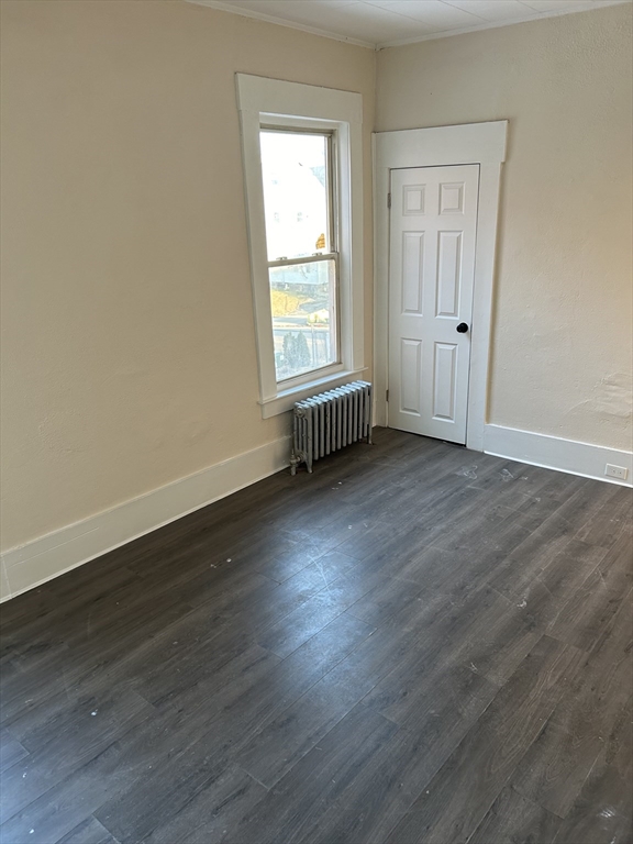 230 Pleasant Street, Unit 1 Worcester, MA 01609 - Photo 6 of 8 an empty room with wooden floor and windows