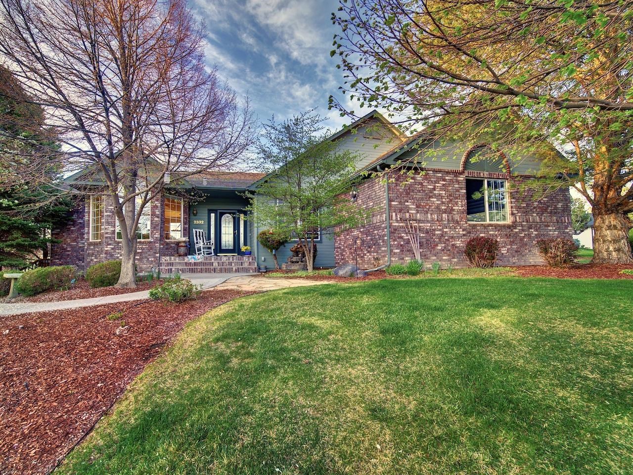 2332 North Falcon Point Court Grand Junction, CO 81507 - Photo 1 of 39 a front view of a house with garden