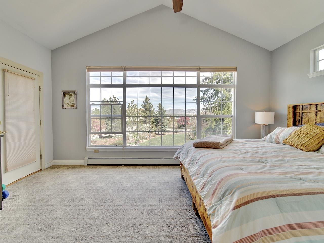 2332 North Falcon Point Court Grand Junction, CO 81507 - Photo 15 of 39 a bedroom with a large bed and a large window