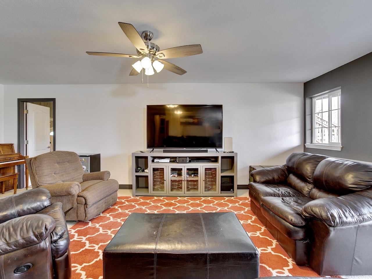 2332 North Falcon Point Court Grand Junction, CO 81507 - Photo 21 of 39 a living room with furniture and a flat screen tv