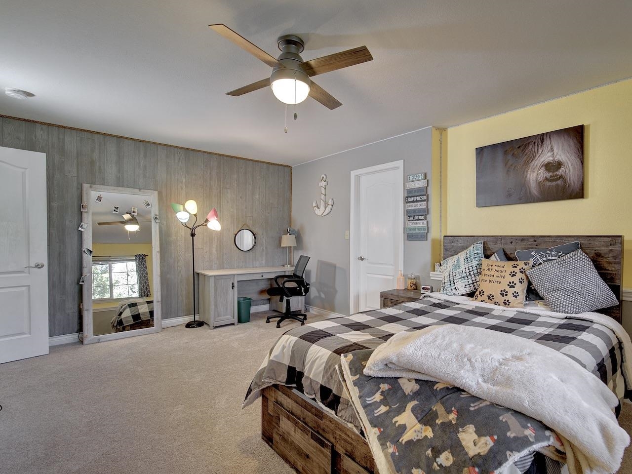 2332 North Falcon Point Court Grand Junction, CO 81507 - Photo 24 of 39 a spacious bedroom with a large bed and a chandelier