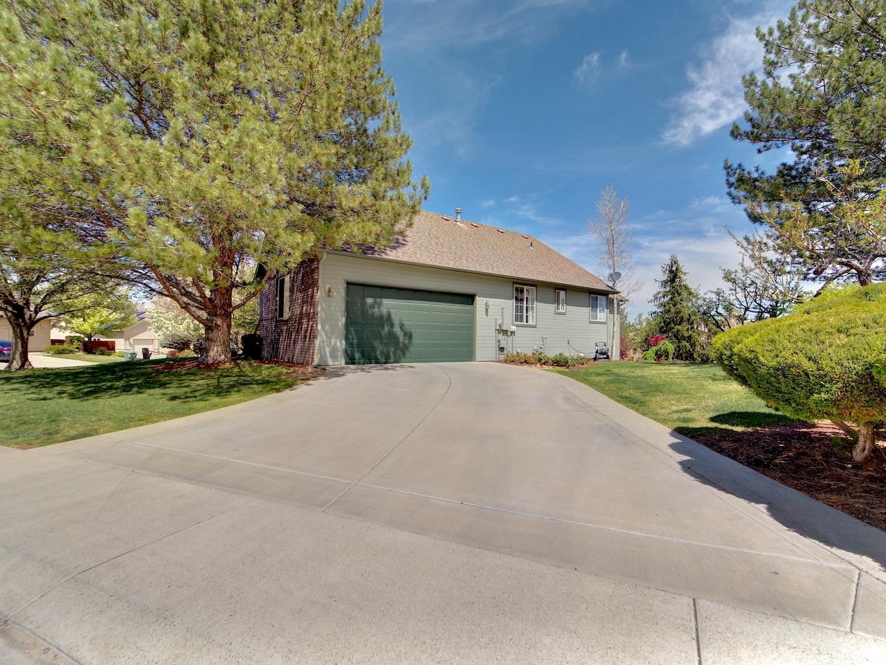 2332 North Falcon Point Court Grand Junction, CO 81507 - Photo 37 of 39 a white house with a large tree in front of it