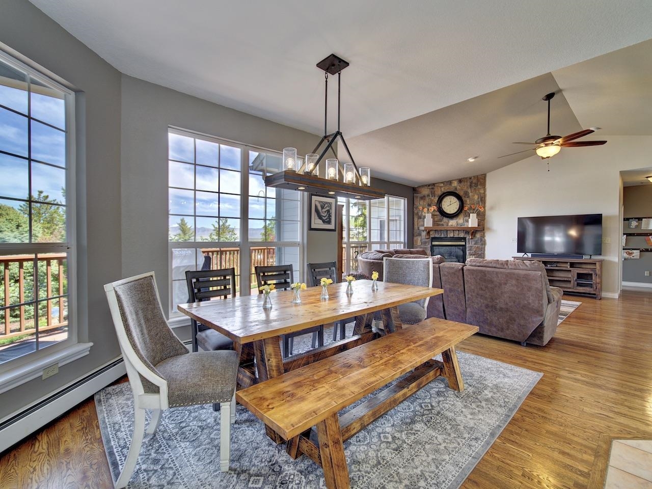 2332 North Falcon Point Court Grand Junction, CO 81507 - Photo 8 of 39 a living room with furniture a dining table and a floor to ceiling window