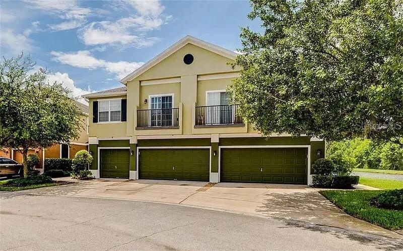 6460 South Goldenrod Road, Unit 30B Orlando, FL 32822 - Photo 1 of 20 a front view of a house with a yard and garage