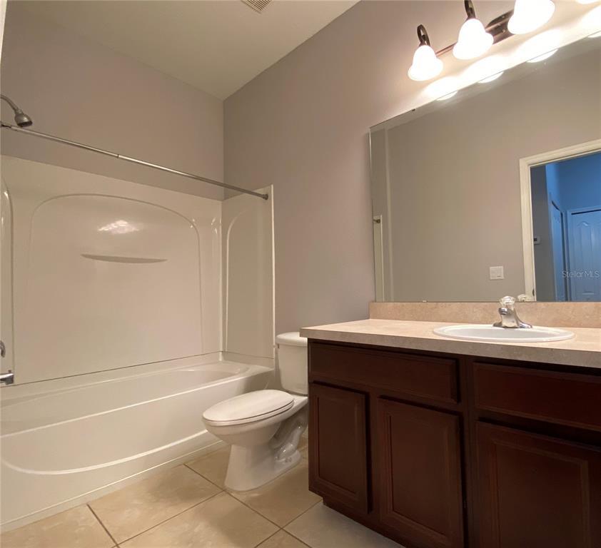 6460 South Goldenrod Road, Unit 30B Orlando, FL 32822 - Photo 15 of 20 a bathroom with a sink a toilet and shower