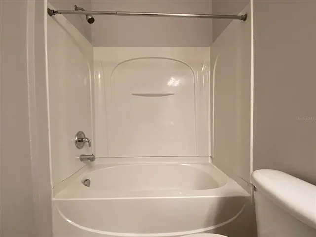 a bathroom with a tub and a shower