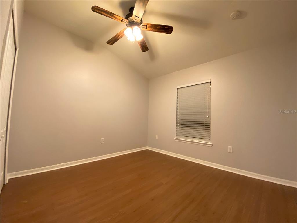6460 South Goldenrod Road, Unit 30B Orlando, FL 32822 - Photo 17 of 20 an empty room with a fan and a window