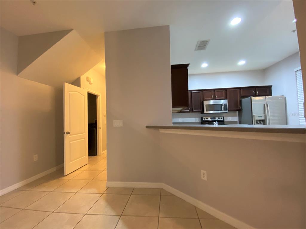 6460 South Goldenrod Road, Unit 30B Orlando, FL 32822 - Photo 6 of 20 a kitchen with stainless steel appliances a refrigerator and a stove top oven