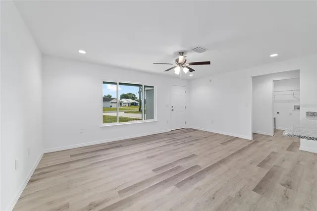 a kitchen with stainless steel appliances kitchen island hardwood floor sink and stove