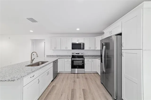 a kitchen with a refrigerator sink and microwave