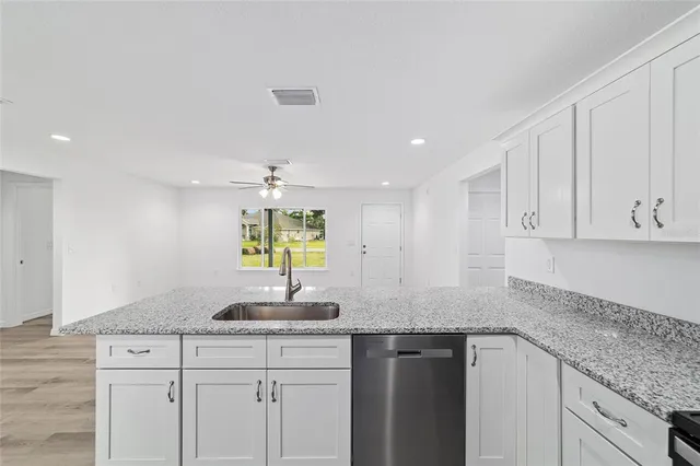 a kitchen with stainless steel appliances granite countertop a sink and a granite counter tops