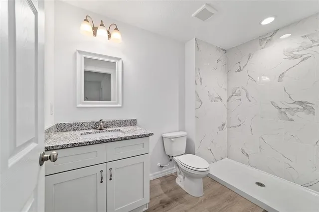 a bathroom with a shower a toilet and a shower