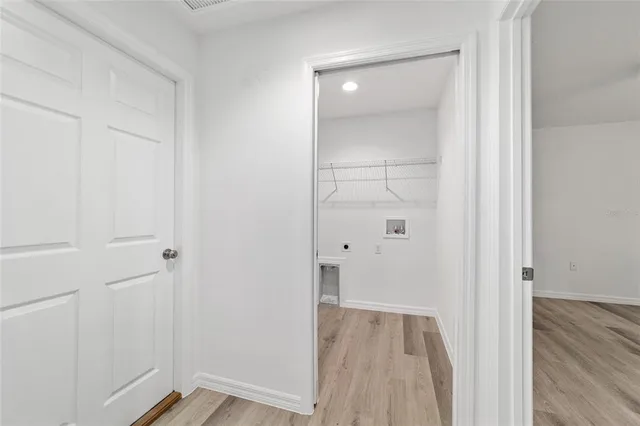 a view of a room with wooden floor