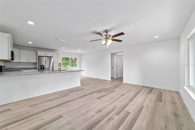 a view of kitchen with sink and wooden floor