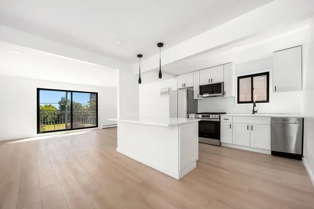 a kitchen with stainless steel appliances a refrigerator and a stove top oven