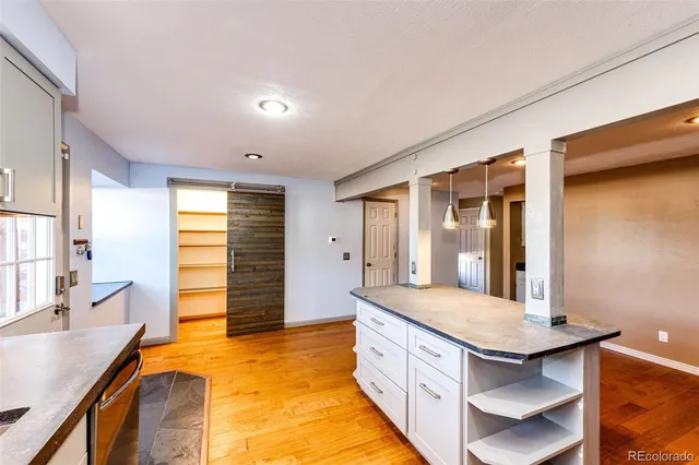 a bathroom with a granite countertop sink and a bathtub
