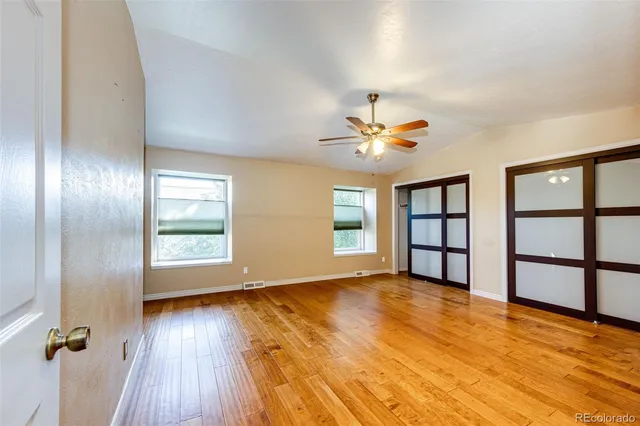 wooden floor in an empty room with a window