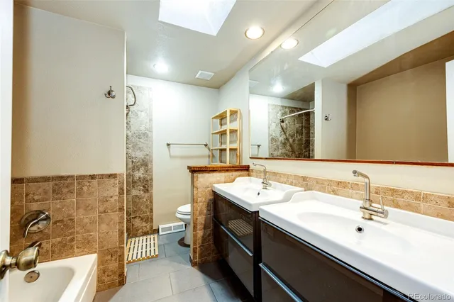 a bathroom with a sink double vanity and a toilet