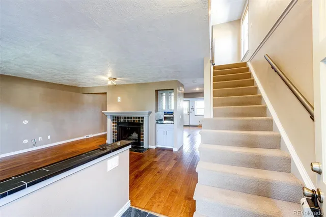 a view of an entryway with wooden floor and a rug