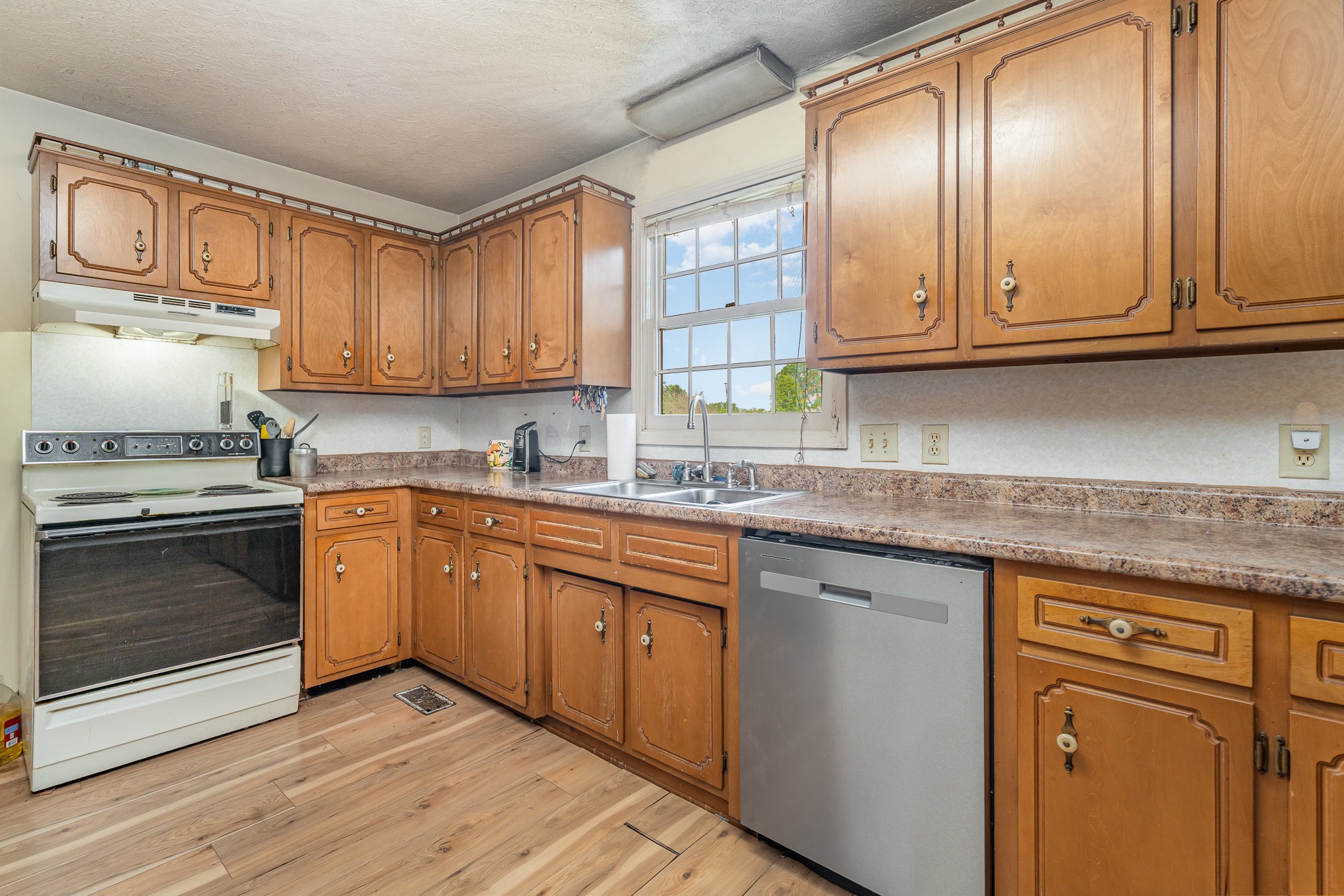 79 Goshen Road Lebanon, TN 37087 - Photo 7 of 27 a kitchen with granite countertop cabinets stainless steel appliances and a sink