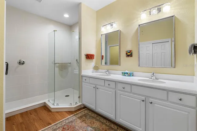 a bathroom with a granite countertop toilet sink and mirror