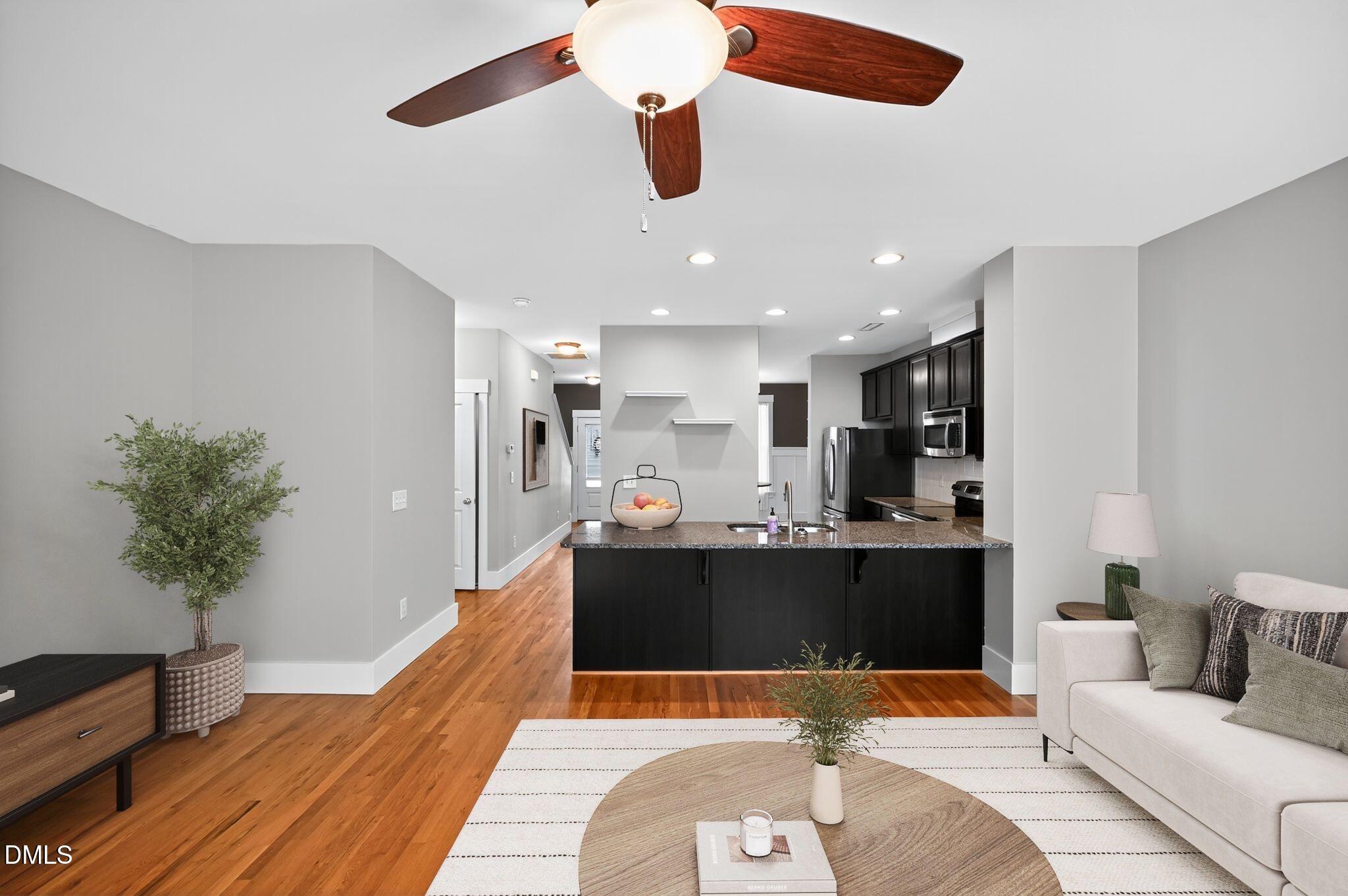 44 Owen Towne Road Chapel Hill, NC 27516 - Photo 5 of 64 a living room with stainless steel appliances kitchen island granite countertop furniture a rug and a potted plant