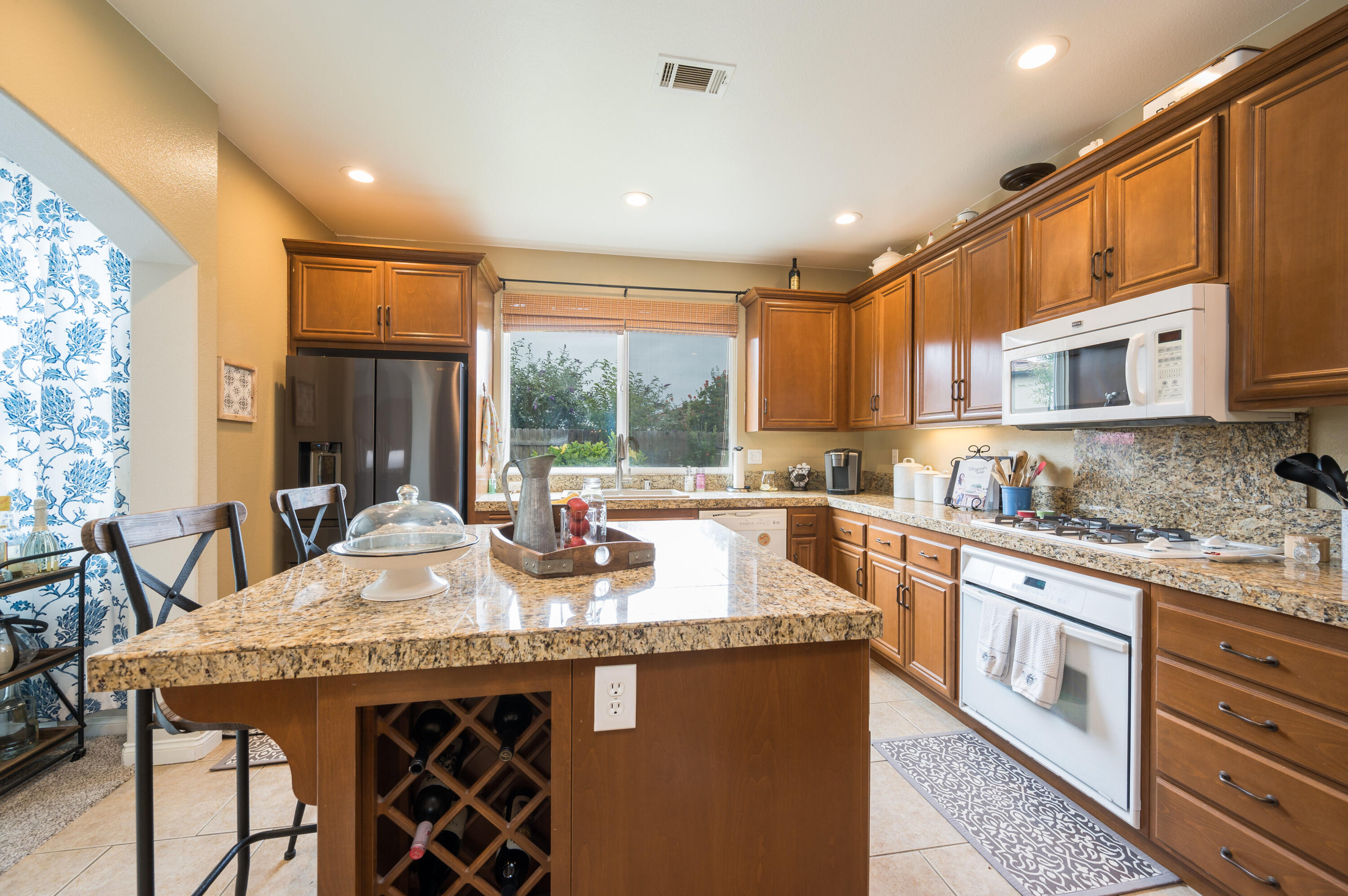 529 Palomar Circle Lompoc, CA 93436 - Photo 16 of 42 a kitchen with stainless steel appliances granite countertop a stove a sink and a microwave
