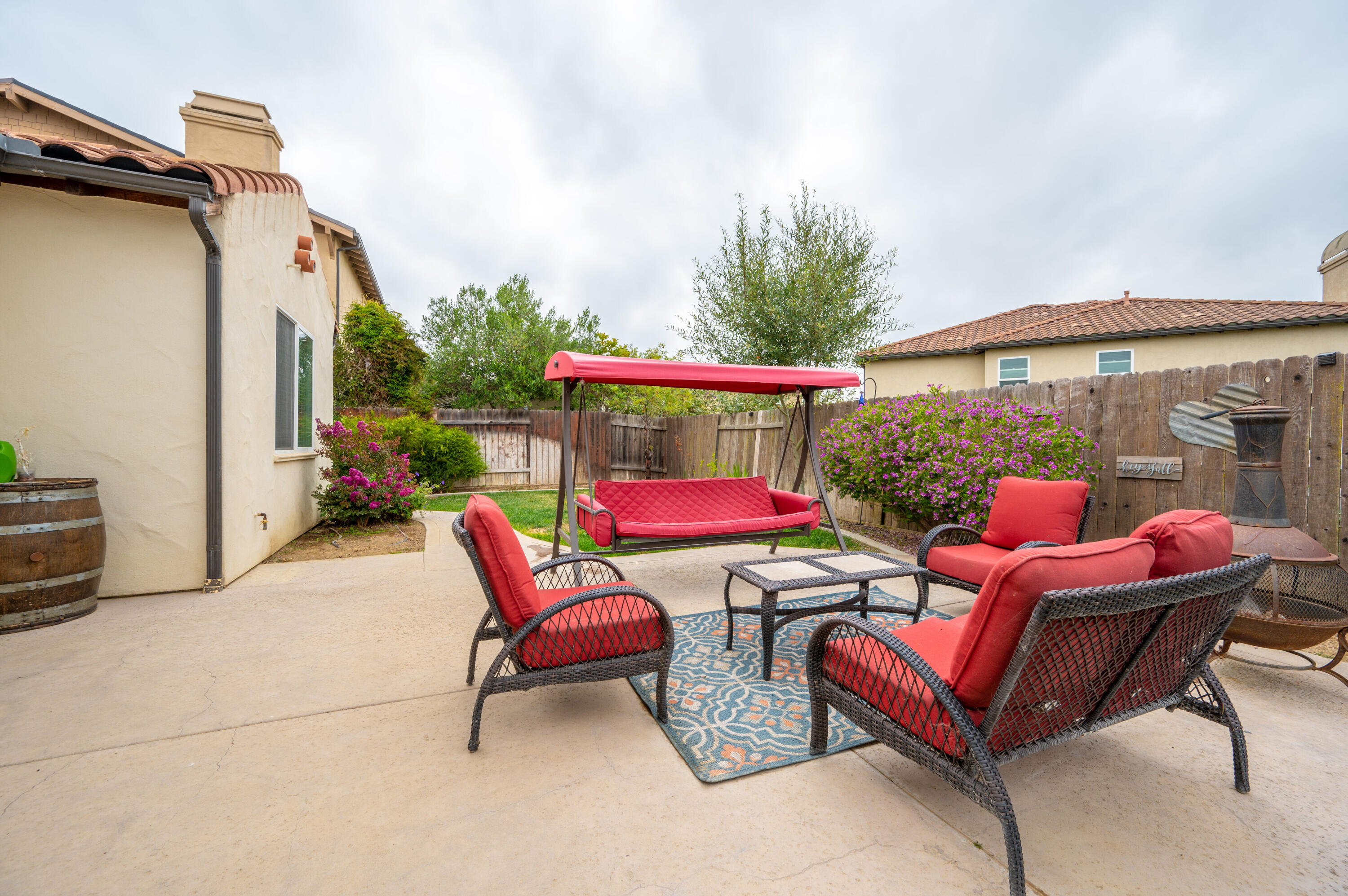 529 Palomar Circle Lompoc, CA 93436 - Photo 35 of 42 a patio with patio a table and chairs under an umbrella