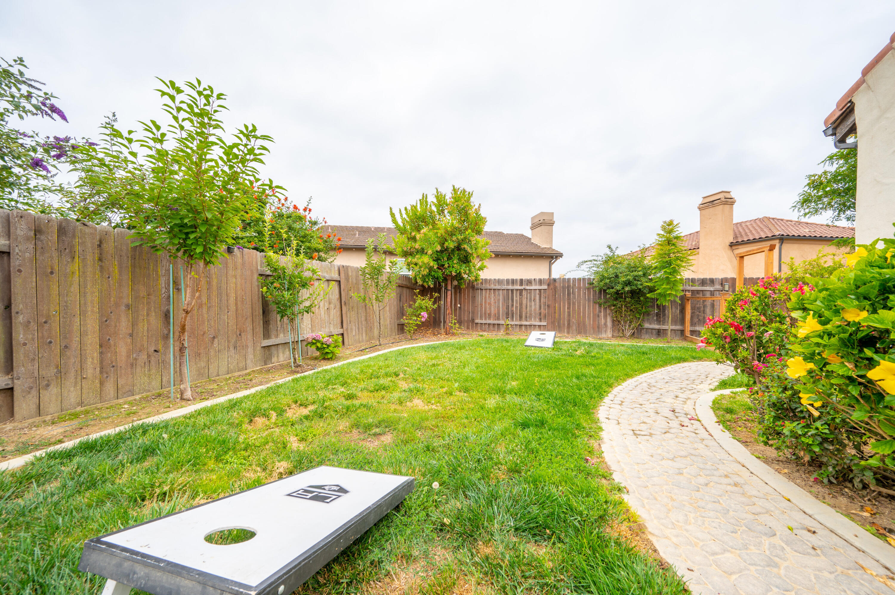 529 Palomar Circle Lompoc, CA 93436 - Photo 36 of 42 a view of a yard with table and chairs and wooden fence