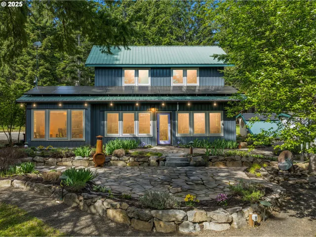 a front view of house with a garden