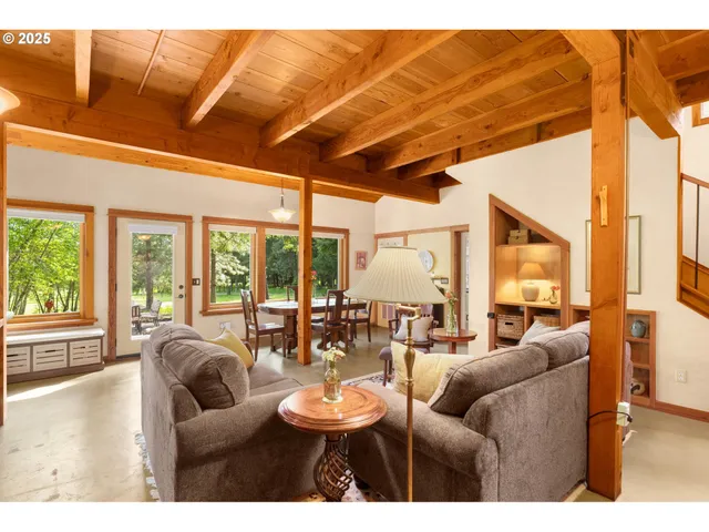 a living room with furniture a large window with outer view