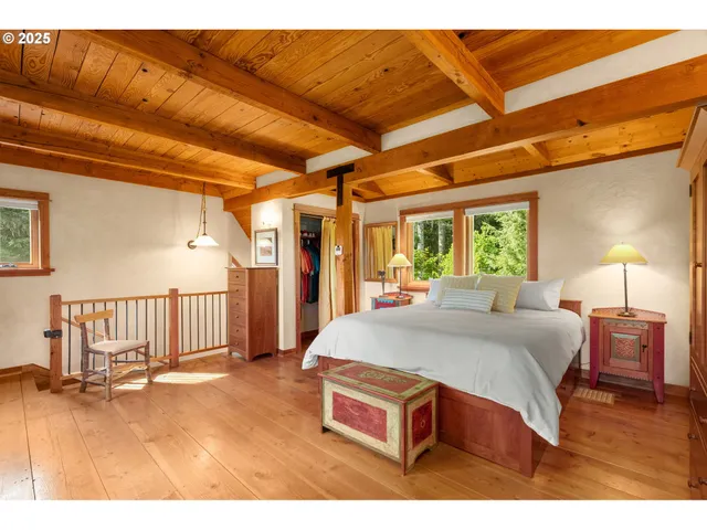 a bed room with a bed and a chair