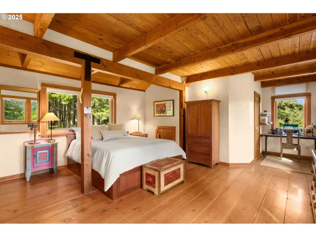 a bedroom with a large bed and a large window