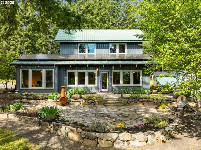 a backyard of a house with table and chairs