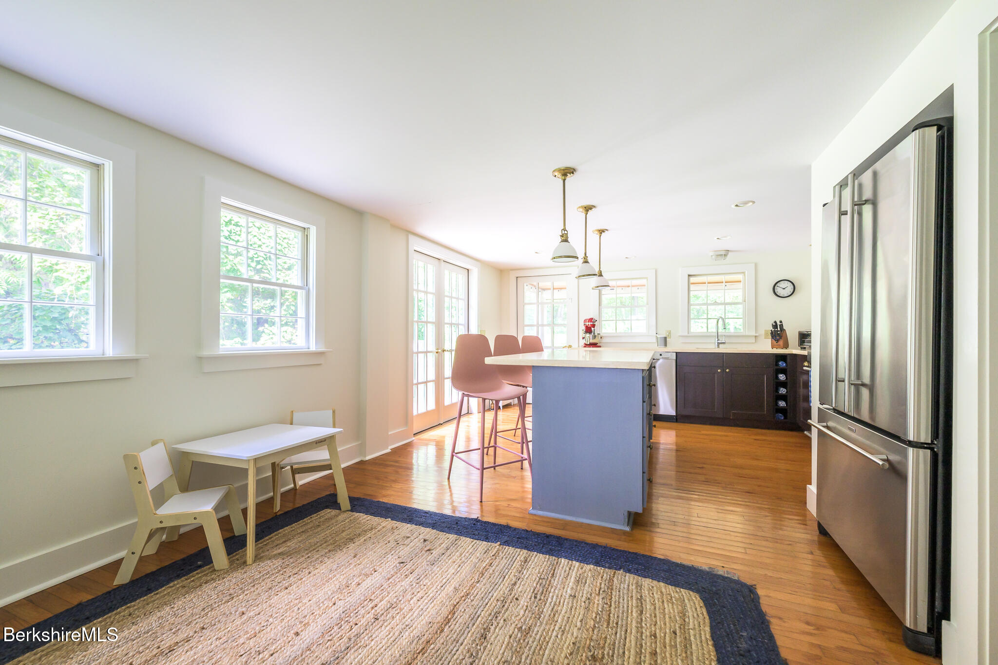 270 Hillsdale Road Egremont, MA 01230 - Photo 12 of 39 a kitchen with stainless steel appliances granite countertop a refrigerator a sink dishwasher a stove and a dining table with wooden floor