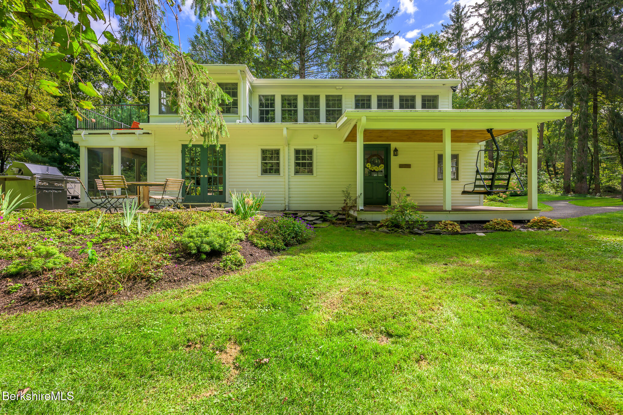 270 Hillsdale Road Egremont, MA 01230 - Photo 30 of 39 a front view of a house with a yard table and chairs