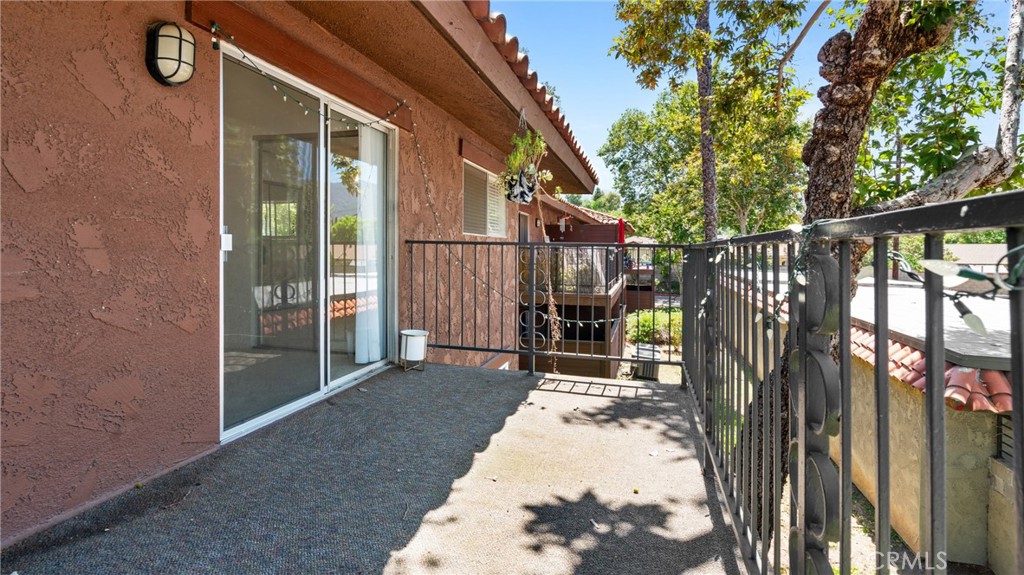 1598 Border Avenue, Unit H Corona, CA 92882 - Photo 19 of 37 a view of a porch with wooden floor and fence
